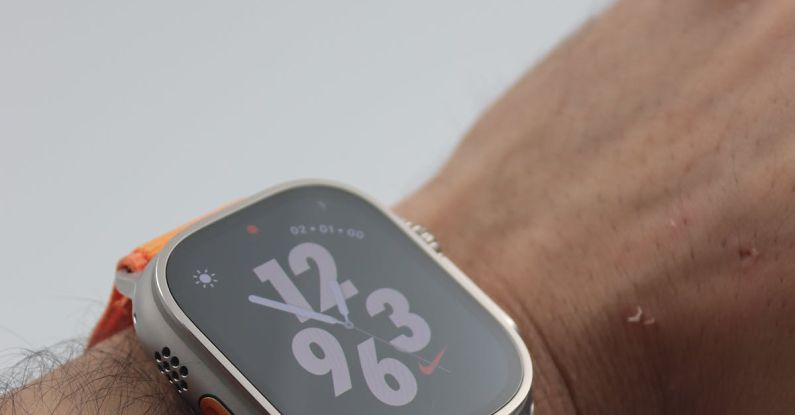 Fintech Innovation - A person wearing an orange watch on their wrist